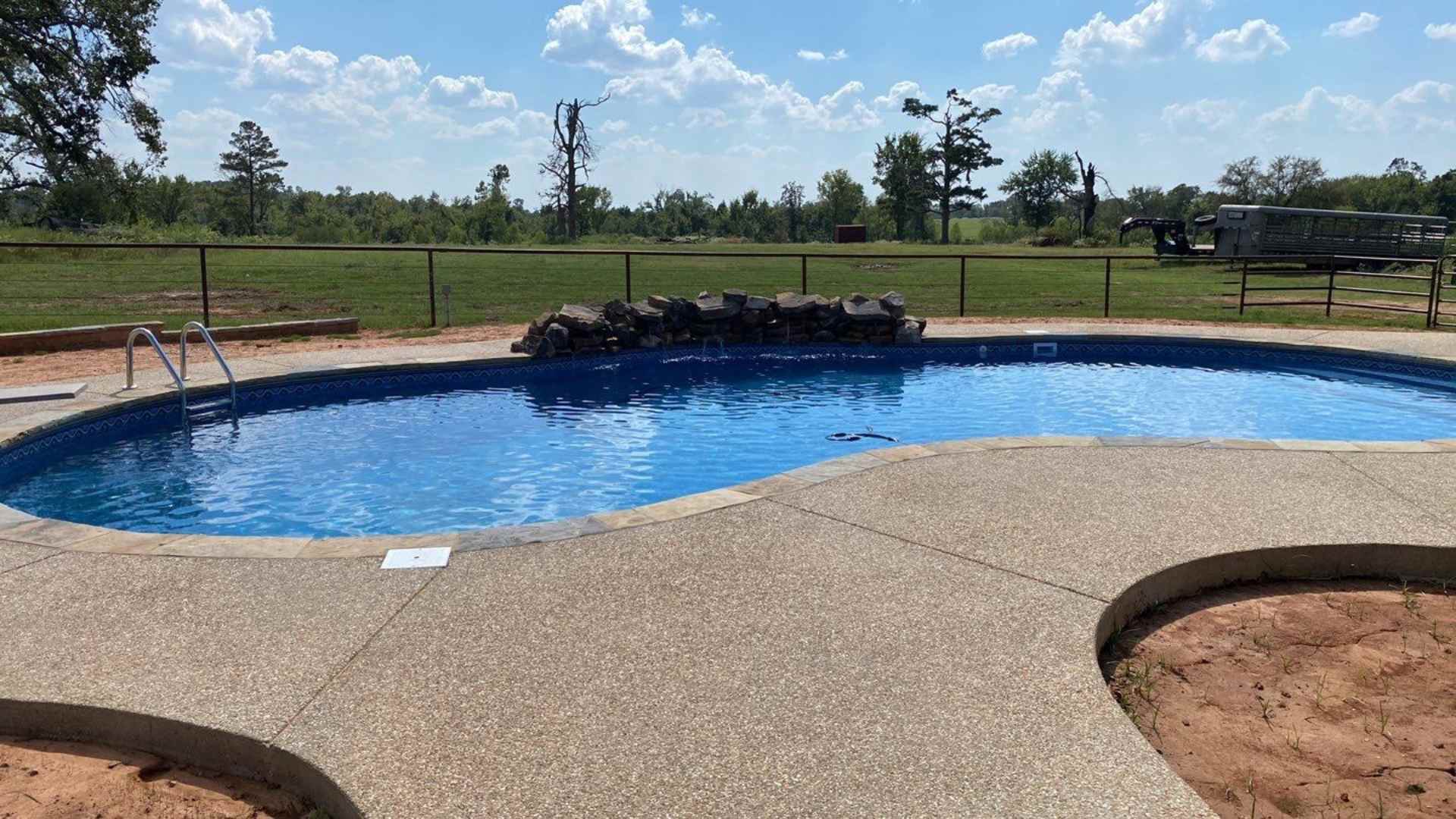 inground vinyl liner pool completion showing waterfall